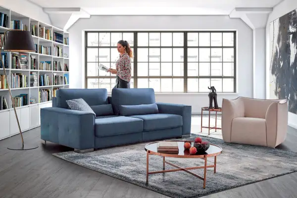 Salon moderne avec canapé bleu, fauteuil beige et bibliothèque. Quelle couleur de canapé choisir pour un style contemporain ?